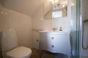 a bathroom with a toilet and a sink and a shower at Casa Nova in Carnota +33 photos