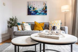 a living room with a couch and a table at Tranquil Belsize Park Haven with Stunning Views in London