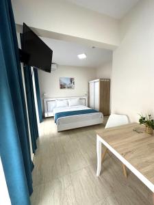 a bedroom with a bed and a table at Navarino Luxe Suites in Perea