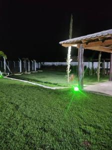a green light on the grass in a park at night at Chalé Canastra Zoo in Capitólio