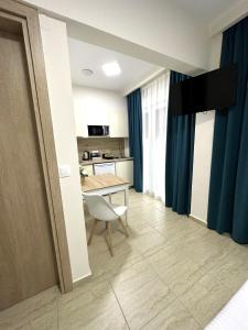 a living room with a table and a kitchen at Navarino Luxe Suites in Perea