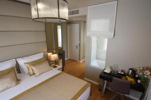 a bedroom with a bed and a desk and a mirror at Luxury Rooms Fortuna in Split