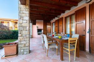 a wooden table and chairs on a patio at Maison Elisa in Montinelle