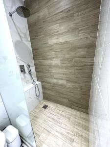 a bathroom with a shower and a toilet at Navarino Luxe Suites in Perea