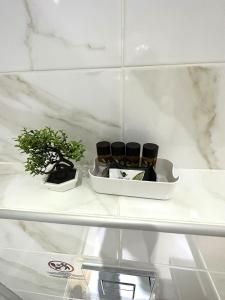 a shelf with three cups and a potted plant on it at Navarino Luxe Suites in Perea