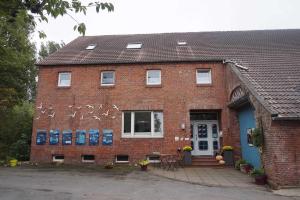 a brick building with writing on the side of it at Gulfhof Friedrichsgroden in Carolinensiel