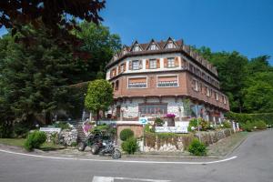 a building with a motorcycle parked in front of it at Hotel Ricordo Du Parc in Tabiano