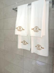 a group of towels are hanging in a bathroom at Navarino Luxe Suites in Perea