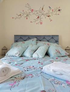 a bed with a blue comforter with flowers on it at Hafan Y Traeth Beach Front Apartment in Barmouth in Barmouth