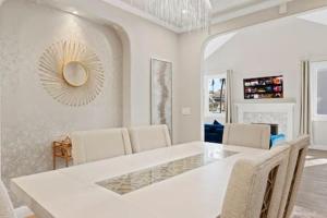 a white dining room with a white table and chairs at Champagne Taste Luxury Home in Hillcrest in San Diego