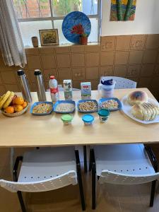 a table with plates of food on it at Guanaco Hostel in Puerto Madryn