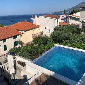 uma piscina em frente a uma casa em Luxury apartment with pool large patio & sea view em Omiš