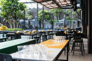 a row of tables and chairs in a restaurant at Sea Beach Hostel & Club AoNang Beachfront in Ao Nang Beach