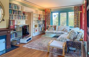 a living room with a couch and book shelves at Cozy Home In Noordwijk Aan Zee With Kitchen in Amsterdam