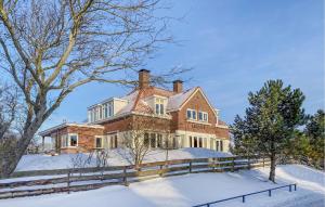 a large brick house in the snow at Cozy Home In Noordwijk Aan Zee With Kitchen in Amsterdam