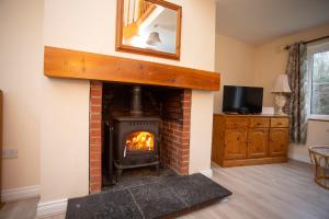 a living room with a brick fireplace with a mirror at Brittas Bay Holiday Village No 32 in Brittas Bay