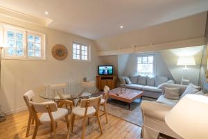 a living room with a table and a couch at Demeure d'Hôtes Haec Otia in Le Touquet-Paris-Plage