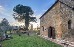 an old stone building with a tree in the background at Lovely Apartment In Volterra With Wifi in Volterra +17 photos