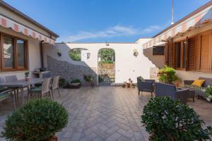 a patio with a table and chairs and a gate at sunny courtyard in Piombino