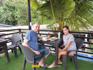a man and a woman sitting at a table at Pamarayeg Room in Bilar