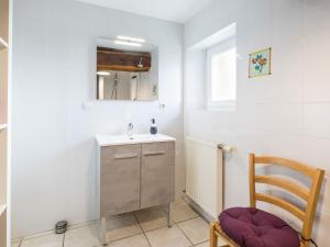 a small bathroom with a sink and a chair at Charmante maison rénovée à 300m de la Loire avec jardin, terrasse, WiFi et équipements bébé - FR-1-306-815 in Saint-Julien-de-Concelles +9 photos