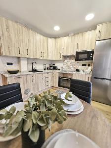 a kitchen with a table with a plant on it at CASA RURAL U FORTI in Valverde del Fresno