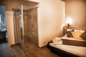 ein Bad mit Dusche und ein Bett mit Kissen in der Unterkunft San Mammaso - Verona Center in Verona