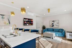 a kitchen and a living room with a blue couch at Caviar Dreams In The Heart of Hillcrest in San Diego