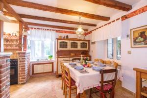 a kitchen with a table and chairs in a room at Holiday house Villa Marija, Pinezici in Krk