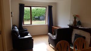 un soggiorno con due sedie e una finestra di Spacious double bedroom in quiet house with garden view a Dublino