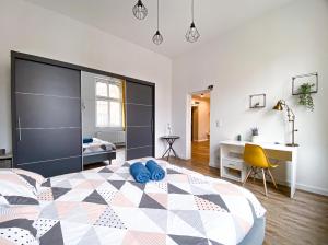 a bedroom with a large bed with blue pillows on it at 31-Vezuvio - DeerRest Apart in Jelenia Góra