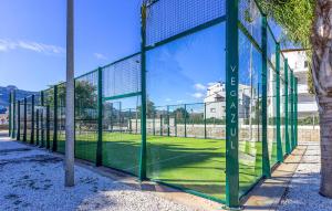 a tennis court with a net on a field at Beautiful Apartment In El Vergel in Denia