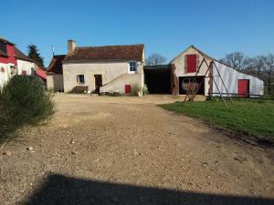an old white house with a barn and a playground at Gîte Ruillé-sur-Loir, 4 pièces, 8 personnes - FR-1-410-134 in Ruillé-sur-Loir