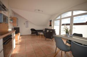 a kitchen and living room with a table and chairs at Atlantik-Kolk 30 in Norddeich