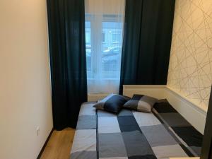 1 cama con 2 almohadas en una habitación con ventana en Apartament Kościuszki 13, en Bydgoszcz