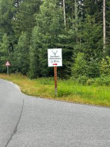 a white sign on the side of a road at Forsthaus Luchsenburg in Ohorn
