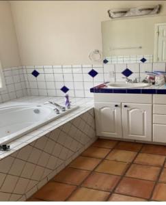 a bathroom with a tub and a sink and a mirror at Home sweet home in Hillsboro