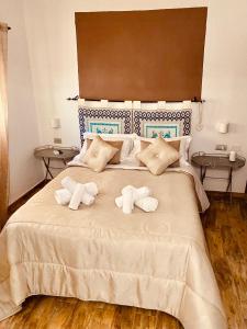 a bedroom with a large bed with towels on it at VILLA di L ABBIU FARMHOUSE , ROOMS DESIGN & RELAX in Sorso