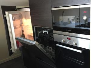 a kitchen with a microwave and a refrigerator at Gîte Cures, 3 pièces, 5 personnes - FR-1-410-321 in Cures