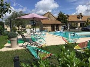 a group of chairs and an umbrella next to a pool at Gîte Cures, 3 pièces, 5 personnes - FR-1-410-321 in Cures