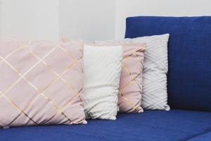 a group of pillows sitting on a couch at Studio Apartment near River and Park by Rent like home in Gdańsk