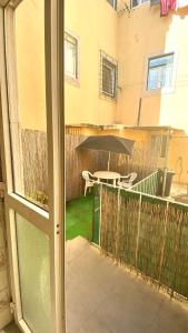 an outside window with a table and an umbrella at Chiado Appartment with Terrace 2 in Lisbon