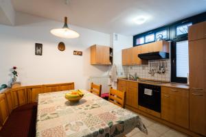 a kitchen with a table with a bowl of bananas on it at Apartment Maj, Kranjska Gora in Kranjska Gora