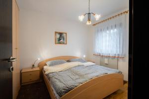 a bedroom with a bed and a window at Apartment Maj, Kranjska Gora in Kranjska Gora