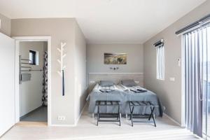 a bedroom with a bed and two chairs at Lax&aacute;rdalur Cabin in Einarssta&eth;ir