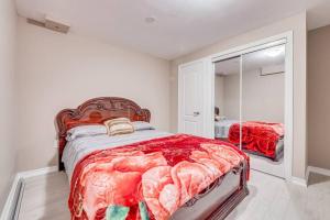 a bedroom with a large bed and a mirror at Hidden Gem: Spacious Basement in Milton