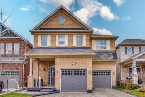 a large brick house with two garages at Hidden Gem: Spacious Basement in Milton