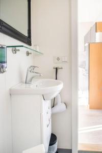 a bathroom with a sink and a mirror at Laxárdalur Cabin in Einarsstaðir