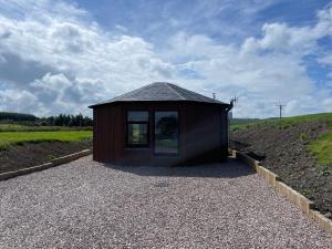 a small building on the side of a hill at AC/DC Glamping in New Aberdour