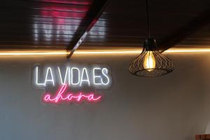 a neon sign that says la violias alfa on a wall at Villa Colorín in Córdoba